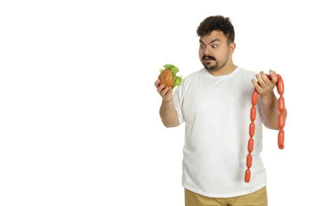 Concept van gewichtsproblemen, jonge dikke man geïsoleerd op witte achtergrond - Foto, afbeelding
