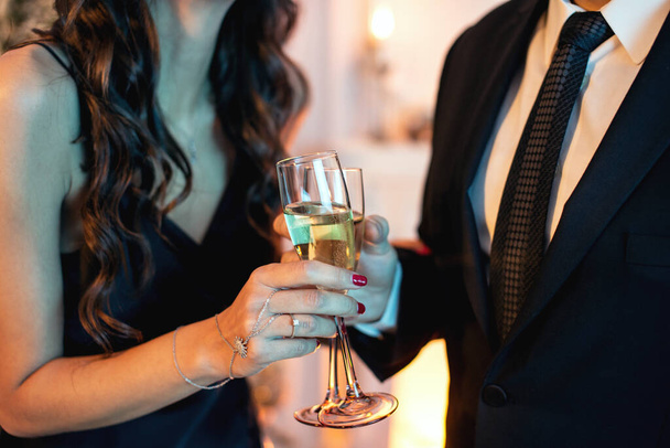 Close up shot of an elegant couple toasting glasses with champagne - Fotoğraf, Görsel