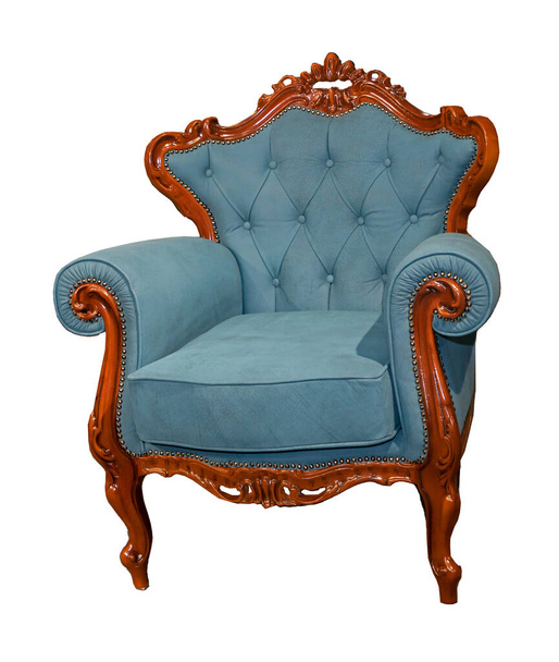 Old vintage armchair with carved brown wooden frame and blue textile upholstery isolated on white background - Foto, imagen