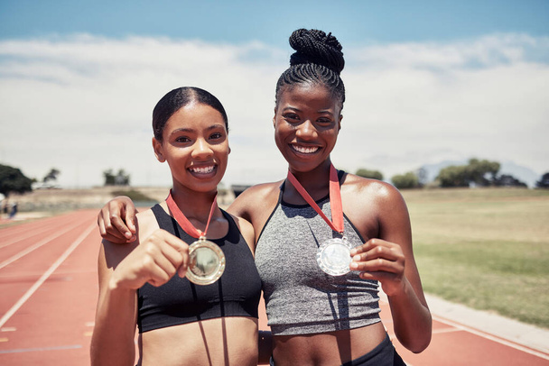 Fitness, friends or black woman with medals for winner, sports victory or wellness race success at sport stadium. Runner, portrait or gold award teamwork for training, exercise or workout with smile. - Fotoğraf, Görsel