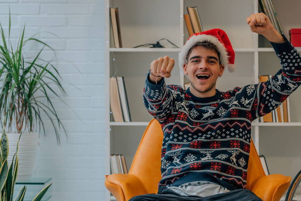 young man at christmas at home excited with joy - Photo, Image