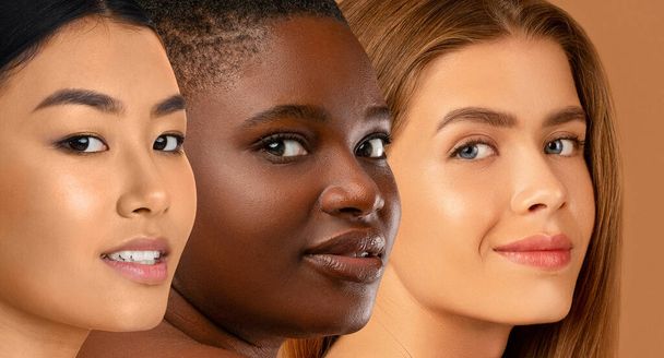 Beautiful faces of young multicultural women smiling at camera on beige studio background, attractive ladies demonstrating perfect skin, closeup, collage. Beauty, skin care, face care concept - Фото, изображение