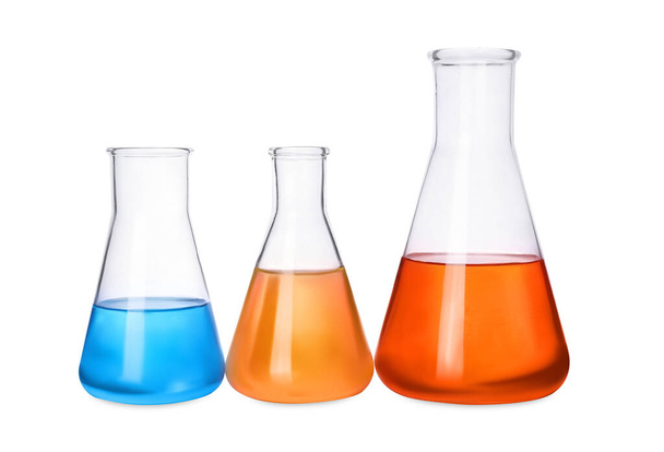 Laboratory glassware with colorful liquids on white background - Fotografie, Obrázek