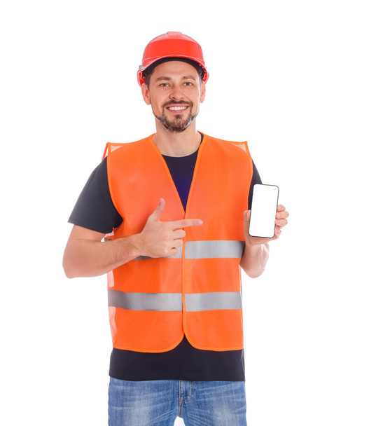 Male industrial engineer in uniform with phone on white background - Foto, afbeelding