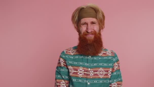 Displeased upset hippie redhead bearded man reacting to unpleasant awful idea, dissatisfied with bad quality, wave hand, shake head No, dismiss idea, dont like proposal. Hipster guy on pink background - Footage, Video
