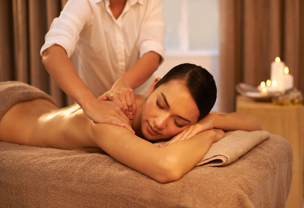 Stress be gone. A beautiful young woman enjoying a massage at the spa - Fotografie, Obrázek