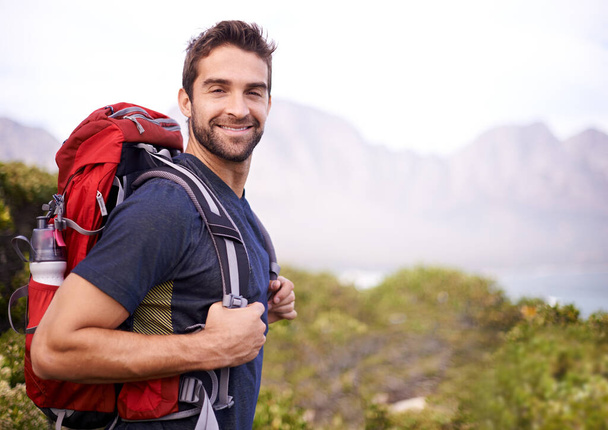 Explore. Dream. Discover. a young man enjoying a hike through the mountains - 写真・画像