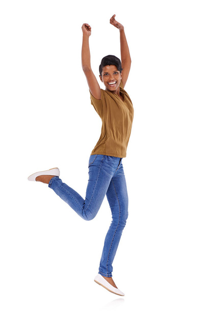 Jump for joy. Studio portrait of an attractive young woman posing against a white background - Photo, Image