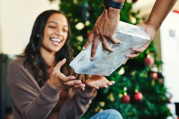 Couple, bonding or hands and christmas gift box in house or home living room for holiday celebration, festive vacation or surprise giving. Smile, happy or xmas woman with present from man in Portugal. - Fotoğraf, Görsel