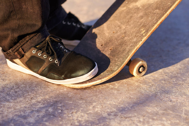 Let me take you for a slide. Cropped image of a teenager on his skateboard - Fotó, kép