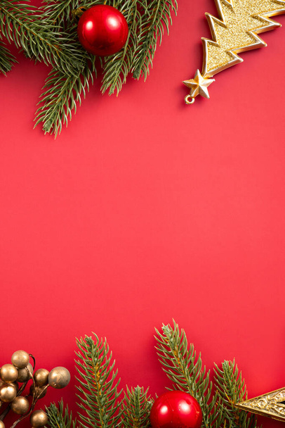 Christmas background design concept, holiday decoration ornament composition with Christmas tree branch, star with copy space isolated on red table. - Φωτογραφία, εικόνα