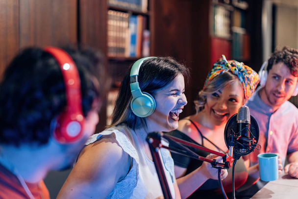 young people having fun in on line streaming podcast - selective focus on headphones - Foto, Imagen