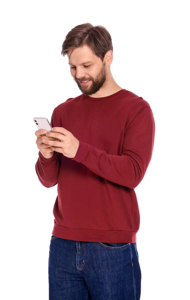 Man in casual clothes with smartphone on white background - Zdjęcie, obraz