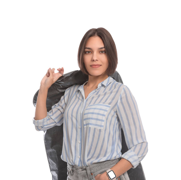 Woman holding garment cover with clothes on white background. Dry-cleaning service - Fotografie, Obrázek