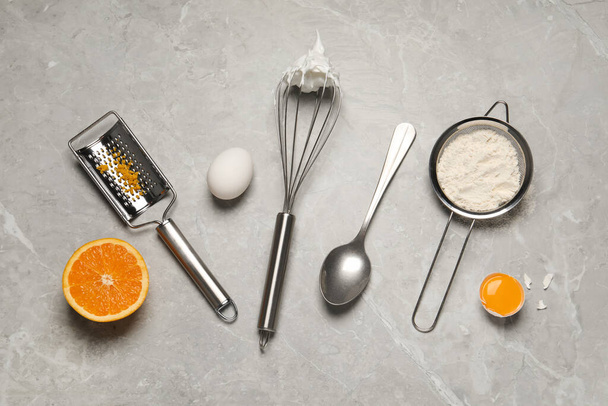Flat lay composition with different tools for cooking on light grey marble table - Foto, Imagen