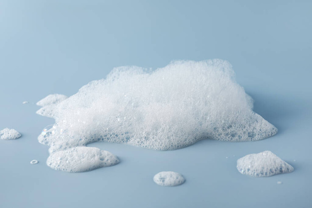 Fluffy bath foam on light blue background - Foto, Imagem