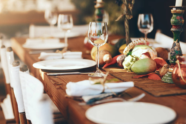 Thanksgiving, christmas and table decoration for lunch, party and celebration with glasses, plate or zoom in home. Dinner table, wineglass or holiday event or celebration xmas, feast or table setting. - Foto, Imagen