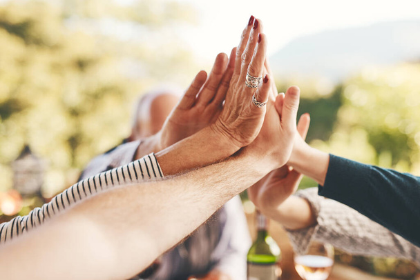 Support, high five and community with hands of family at dinner table for celebration, happy and lunch together. Collaboration, faith and festive with friends relax for solidarity, unity and pride. - Foto, Imagem