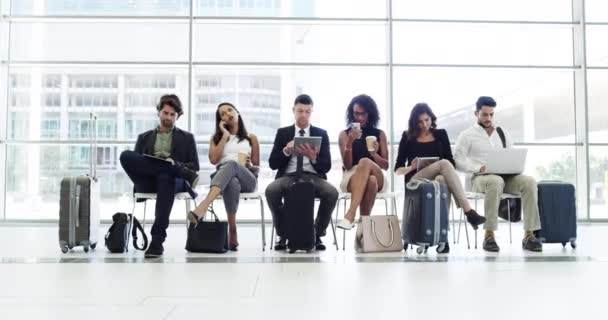 Business people, social networking and waiting room for travel, business trip or corporate team at the airport. Group of employee workers waiting row with luggage to board plane while on social media. - Footage, Video
