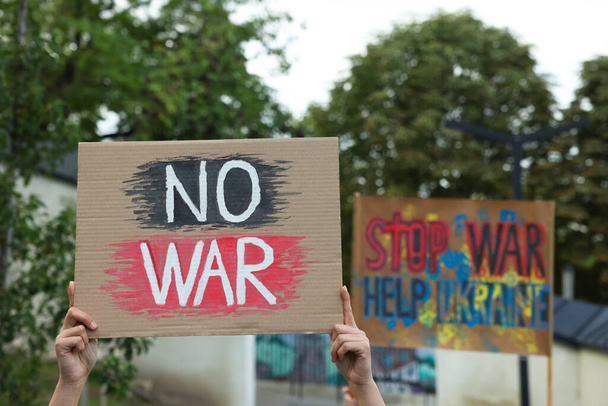 Woman holding poster with words No War outdoors, closeup - Photo, Image