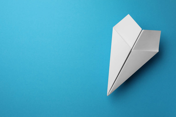 Handmade white paper plane on light blue background, top view. Space for text - Fotó, kép