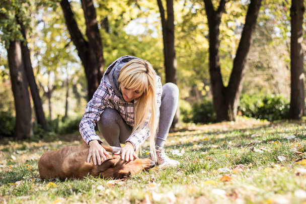 Young woman embracing her dog - Foto, imagen
