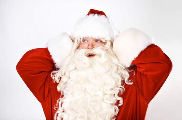 Kafası karışmış, Noel Baba ve stüdyodaki adam beyaz arka plan modeline şaşırmış ve şaşırmış. Noel, kostüm ve yaşlı adam iyi haberler, duyurular ve şenlikli ruhla şaşkına döndü.. - Fotoğraf, Görsel