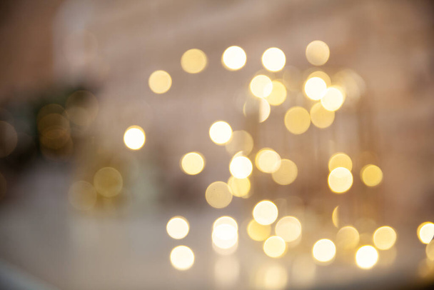 Blurred festive background with gold lights. New year backdrop - Foto, imagen