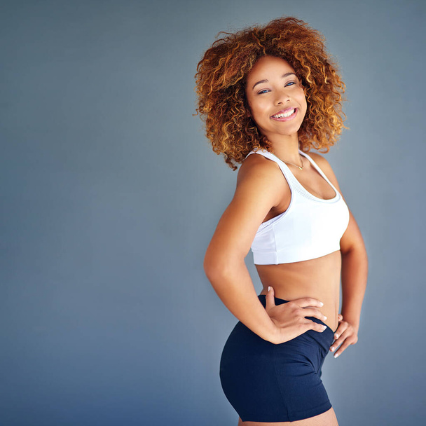 Sports, beauty and portrait of confident black woman with happy face and mockup on blue background. Fitness, health and wellness, woman with afro with smile, motivation and healthy mindset in studio - Fotografie, Obrázek