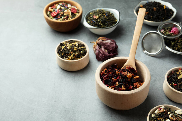 Many different herbal teas on grey table - Zdjęcie, obraz