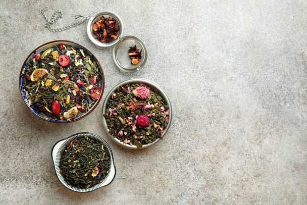 Many different herbal teas on grey table, flat lay. Space for text - Фото, изображение