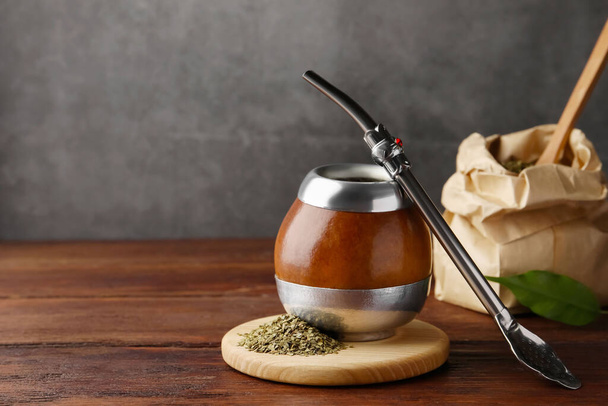 Calabash with mate tea and bombilla on wooden table. Space for text - Photo, image
