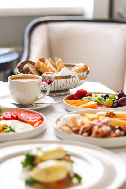 Luxury hotel and five star room service, various food platters, bread and coffee as in-room breakfast for travel and hospitality brand - 写真・画像