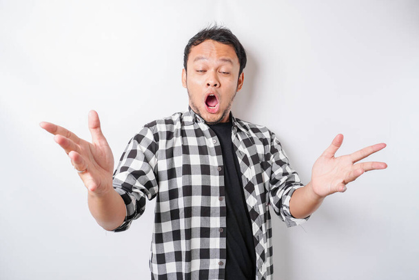 A portrait of a shocked Asian isolated by a white background - 写真・画像