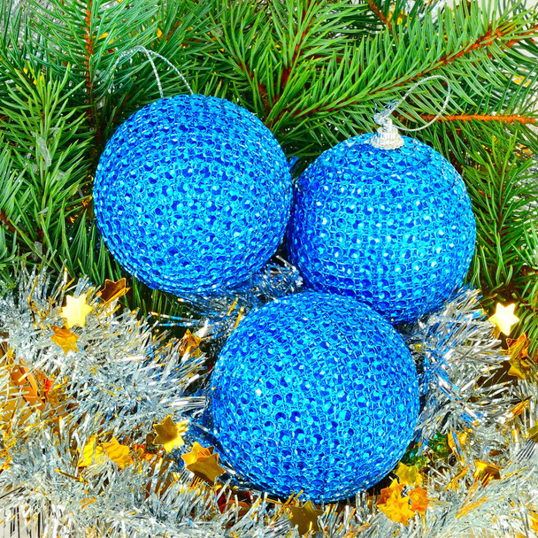 A sprig of fir, blue Christmas balls and shiny tinsel background. - Fotografie, Obrázek
