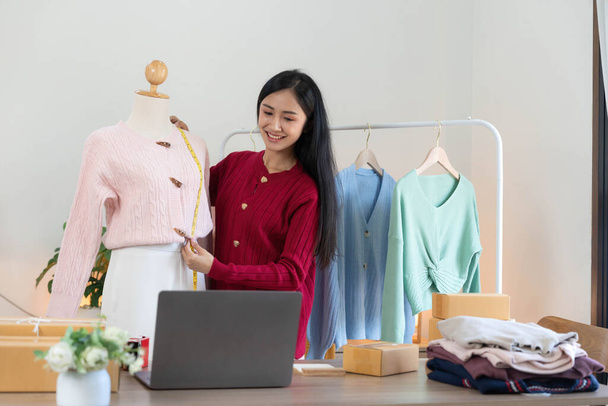 Portrait of Starting small businesses SME owners, Asian woman check online orders Selling products working with boxs freelance work at home office, sme business online small medium enterprise.. - Foto, imagen