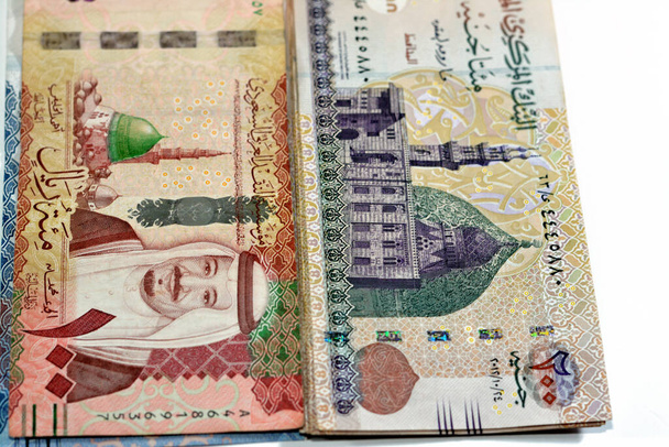 One hundred Saudi Arabia riyals cash money banknote 100 SAR features king Salman and the prophet mosque with 200 LE EGP two hundred Egyptian pounds features Qani Bay mosque, money exchange rate - Фото, зображення