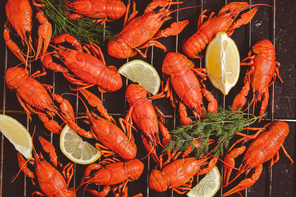 Cooked river crayfish with lemon and herbs are laid out grill - Foto, immagini