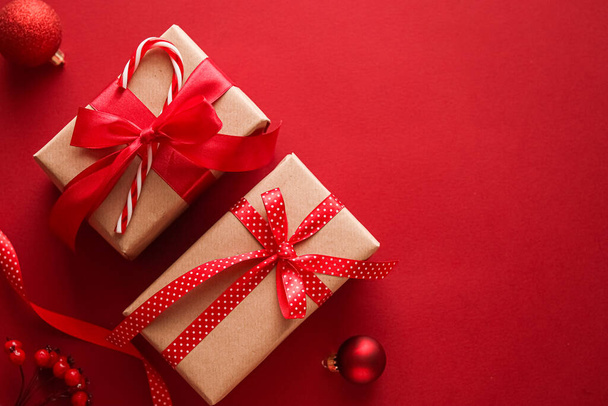 Kerstgeschenken, boksdag en traditionele vakantie cadeautjes plat lay, klassieke kerst geschenkdozen op rode achtergrond, verpakt cadeau met feestelijke ornamenten en decoraties voor vakantie flatlay ontwerp - Foto, afbeelding