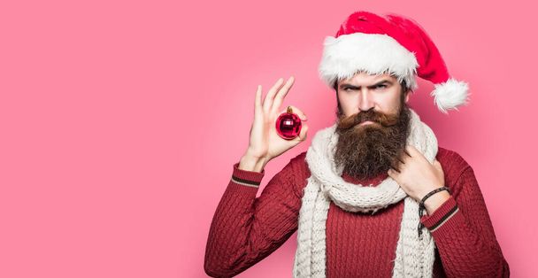 Bearded santa man, christmas card, new year banner with copy space. Funny santa isolated over red studio background - 写真・画像
