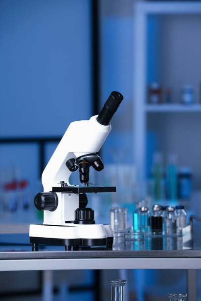 Modern medical microscope on metal table in laboratory - Zdjęcie, obraz
