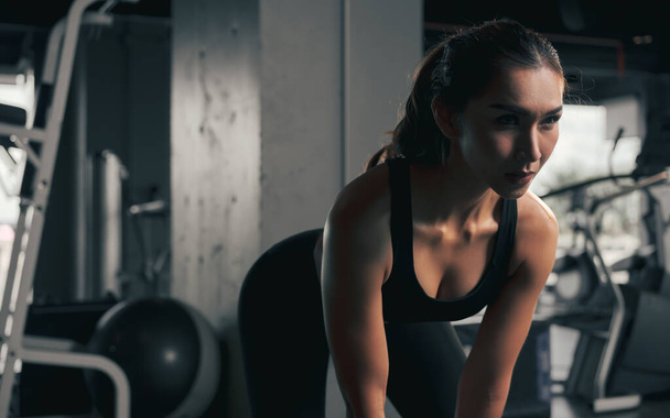 Close-up young woman lifts single kettlebell in the gym. - Photo, Image