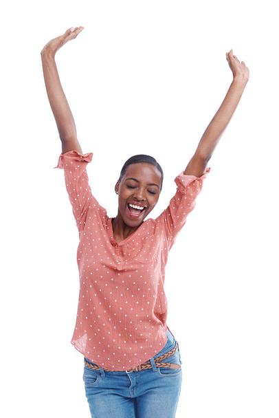 Im the winner. Studio shot of a young woman with arms raised in celebration - Foto, imagen