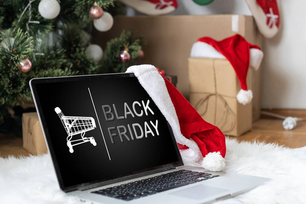 online shopping concept. Close-up top view of a man with black friday offers on laptop. all screen graphics are made up. High quality photo - Photo, Image