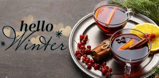 Banner with tasty mulled wine and text HELLO WINTER on grunge background - Photo, Image