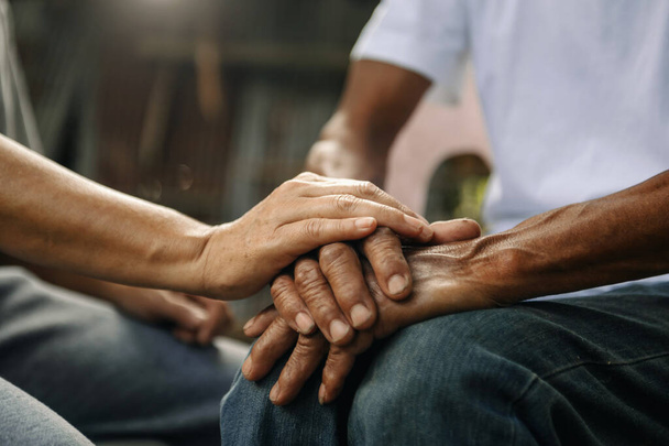 cropped image of person supporting elderly man. care and love of family concept, people holding hands together  - Photo, image