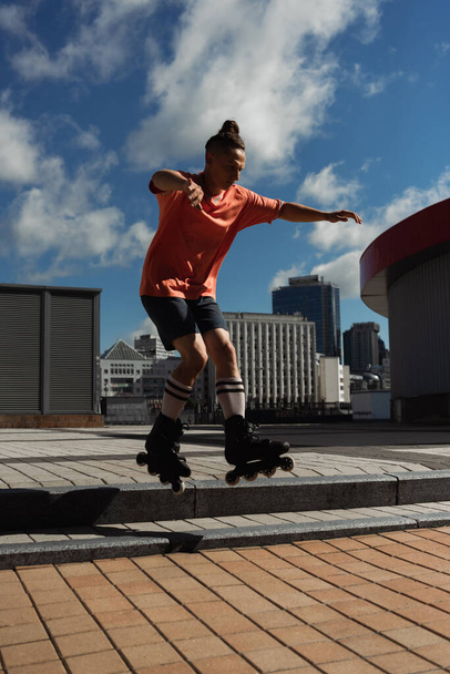 stylish roller skater jumping from stairs while doing trick on urban street - Foto, Imagem