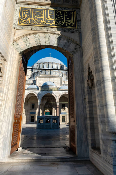 Suleymaniye Mosque entrance with Quran text, old ancient structure, vertical view of mosque gate, Muslim and Islam concept, exterior: Suleymaniye Mosque, Istanbul, Turkey - Photo, image