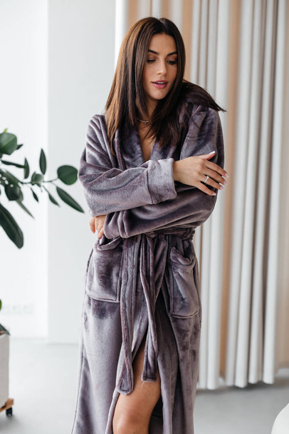 Young healthy serene woman girl relaxing in bathrobe and spa towel after having bath shower at home. Beauty treatment, rest and body care procedures. High quality photo - Foto, immagini