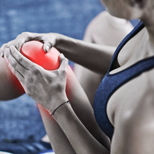 Cibler la douleur. une jeune femme tenant son genou blessé c'est surligné en rouge - Photo, image